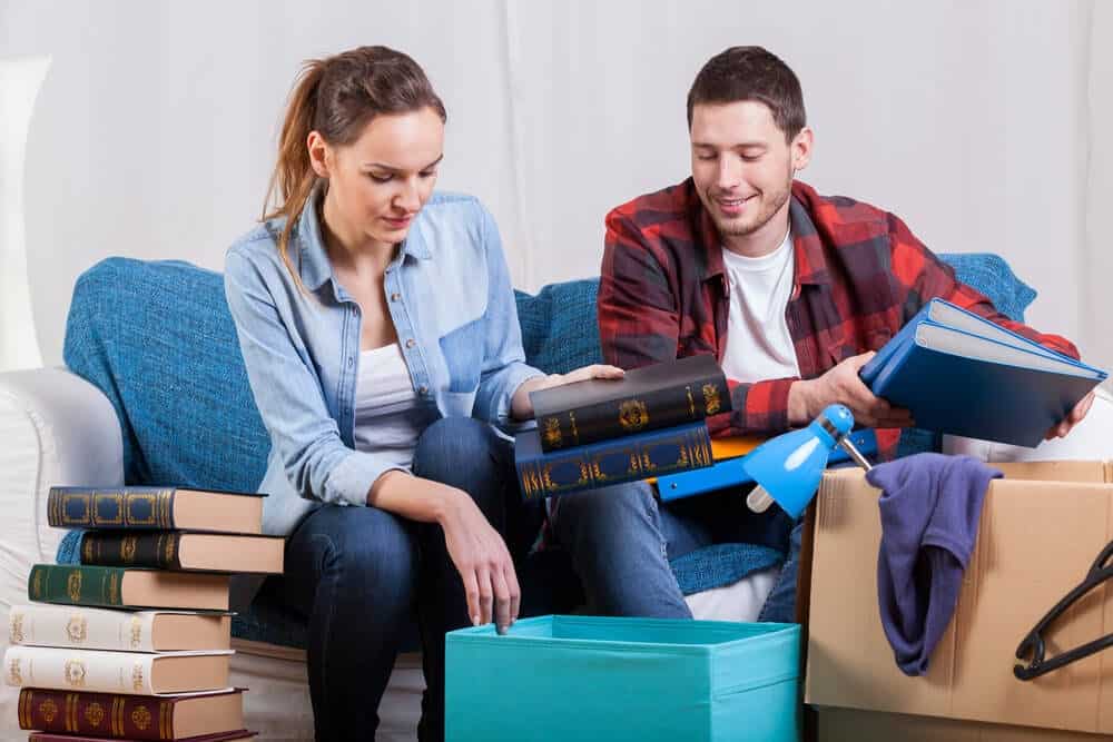 couple packing books for house move