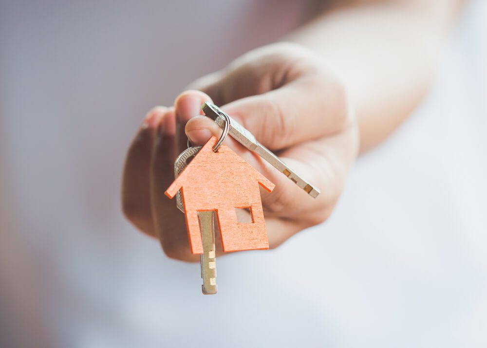 image of person holding keys to new house